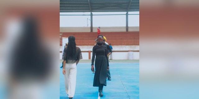 Models walking an outdoor runway in Ibadan, Nigeria, used as illustrative fashion-show imagery.