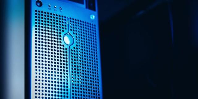 Close-up of a blue-lit server rack in a data centre, used as illustrative infrastructure imagery