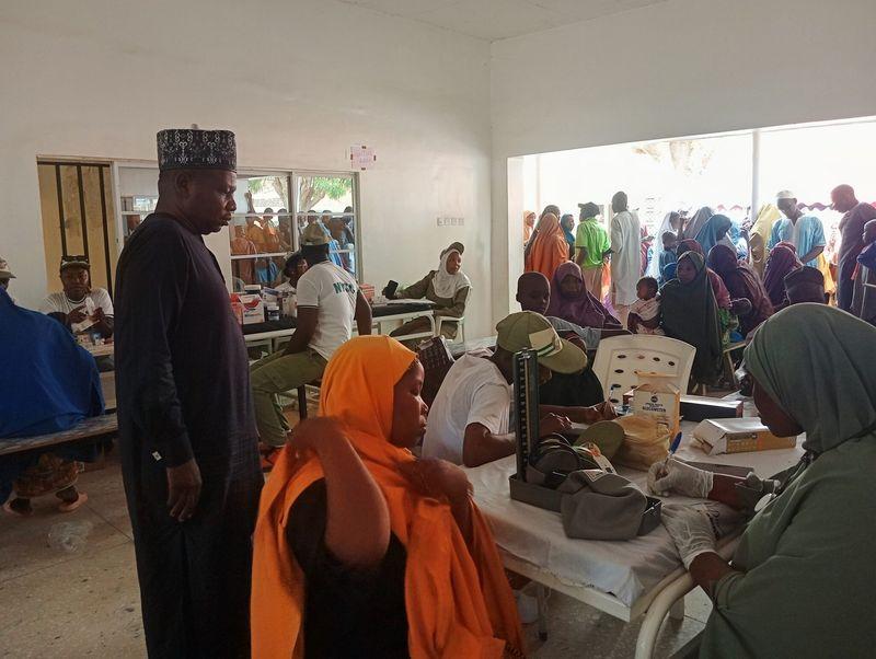 NYSC medical corps members attending to residents during a free healthcare outreach at Chamo Primary Health Care Centre in Dutse, Jigawa State.
