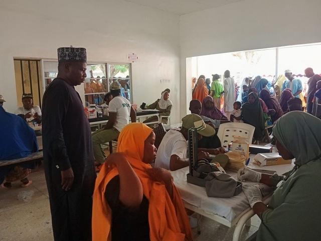 NYSC medical corps members attending to residents during a free healthcare outreach at Chamo Primary Health Care Centre in Dutse, Jigawa State.