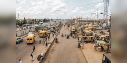 Wide Lagos street scene with traffic and pedestrians, used as illustrative urban context.