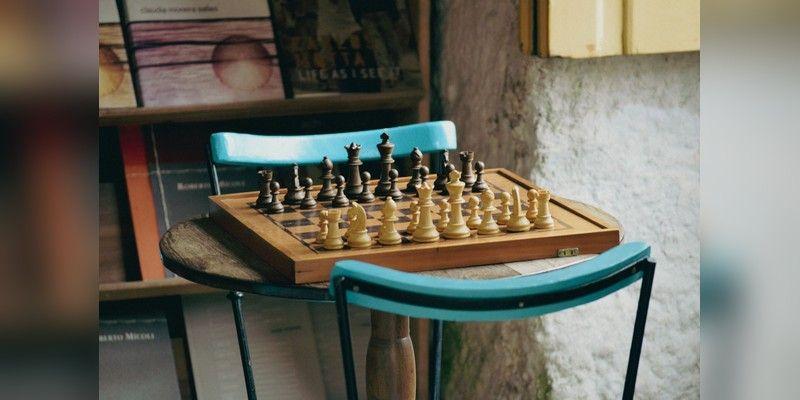 A chessboard set for play on a wooden table, used as safeguarded illustrative chess imagery.