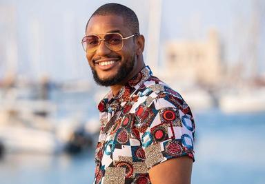 Alex Ekubo smiling at a public event before reports emerged of his death after battling stage 4 liver cancer.