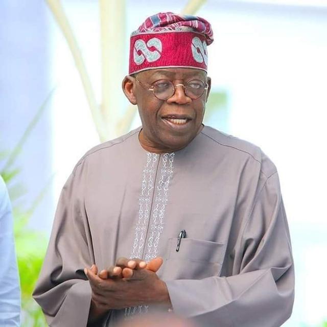 President Bola Tinubu at an APC gathering after the party waived his screening requirement for the 2027 primaries.