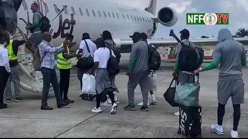 Super Eagles players at Al Abraq Airport, visibly distressed and waiting for updates on their travel situation amid ongoing delays.
