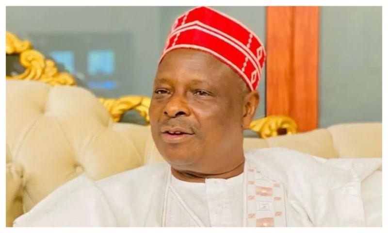 Rabiu Musa Kwankwaso addressing party members at a political gathering alongside prominent Nigerian leaders.