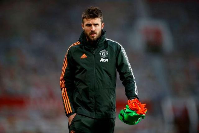 Michael Carrick on the touchline managing Manchester United during a Premier League match amid strong late-season form.
