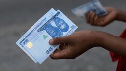 A Nigerian family budgeting household expenses, shopping for groceries and planning finances as part of practical money-saving strategies in 2026.