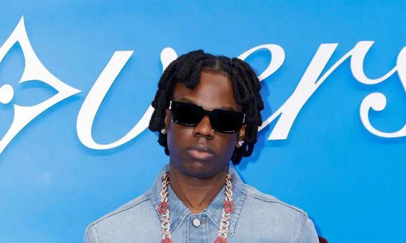 Rema walking the runway at Milan Fashion Week for Diesel, demonstrating his crossover appeal between music and fashion.