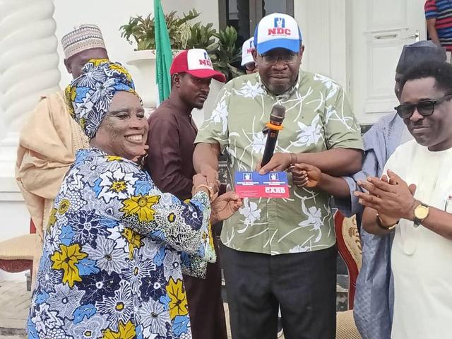 Seriake Dickson presenting NDC membership cards to defectors from ADC, LP, and SDP in Abuja.