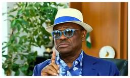 Nyesom Wike addressing journalists during a media parley in Abuja with microphones visible
