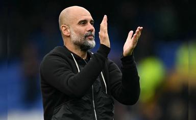 Pep Guardiola speaking on the touchline during a Manchester City match while analysing Arsenal