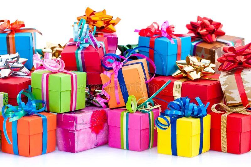 A beautifully arranged collection of lifestyle gifts including a wellness hamper, insulated water bottle, Bluetooth speaker, travel accessories and gift box on a wooden table.