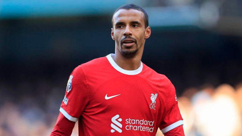 Joel Matip celebrating a goal with teammates during a Liverpool match, showcasing his iconic presence on the field.