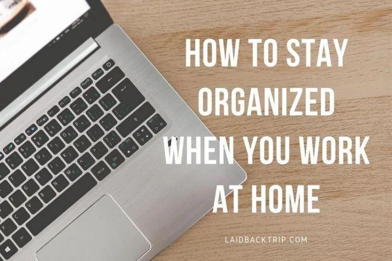 Remote worker using a laptop at a tidy home office with a planner and notebook on the desk.
