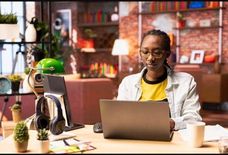 Young Nigerian working on a laptop, representing popular side hustles and online income opportunities in 2026.