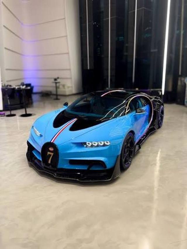 Burna Boy posing beside a Bugatti Chiron, representing luxury, global success and the rise of Nigeria's creative economy.