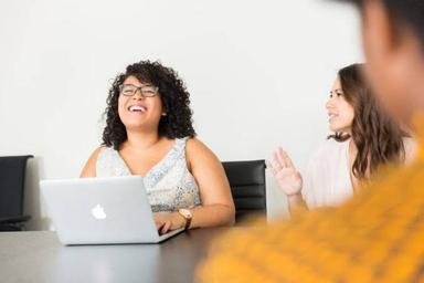 Content manager using project management, analytics, SEO and design tools on a laptop to plan and publish digital content.
