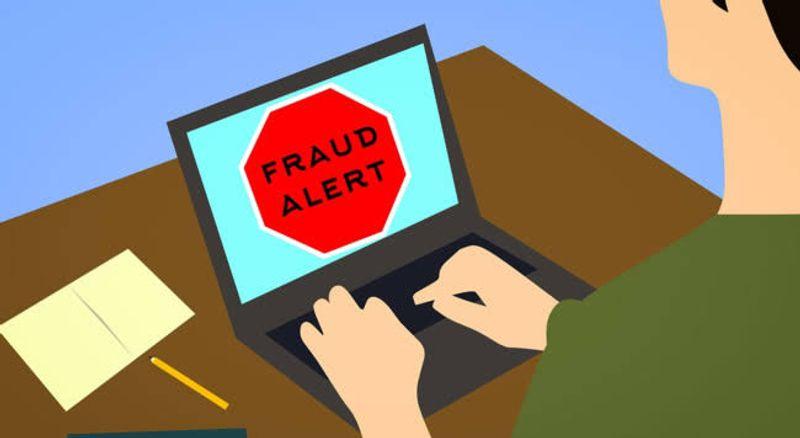 A person using a mobile banking app with a security shield icon, representing protection against online banking fraud and cybercrime.