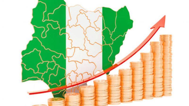 A Nigerian professional reviewing economic charts showing GDP growth, inflation and employment trends to understand their impact on income and jobs.