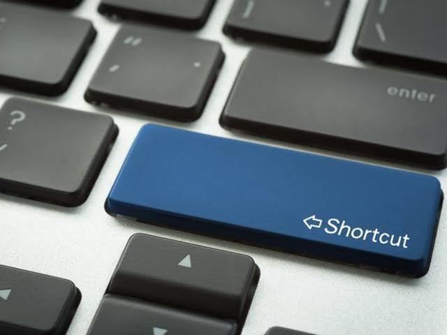Laptop displaying a web browser with keyboard shortcuts highlighted on a nearby keyboard for faster navigation.