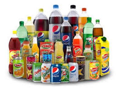 Bottles and cans of popular soft drinks in Nigeria, including Coca-Cola, Fanta, Sprite, Pepsi, 7UP, Mirinda and Schweppes, displayed on a table.