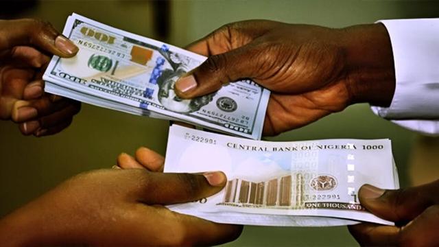Nigerian naira notes alongside US dollar bills illustrating currency exchange fluctuations.
