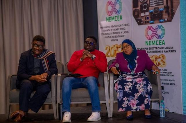 Three professionals on a NEMCEA event panel seated before NEMCEA branding.
