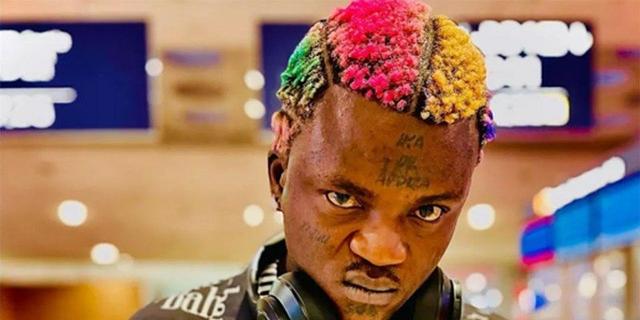 Nigerian street-pop singer Portable wearing headphones and looking at the camera