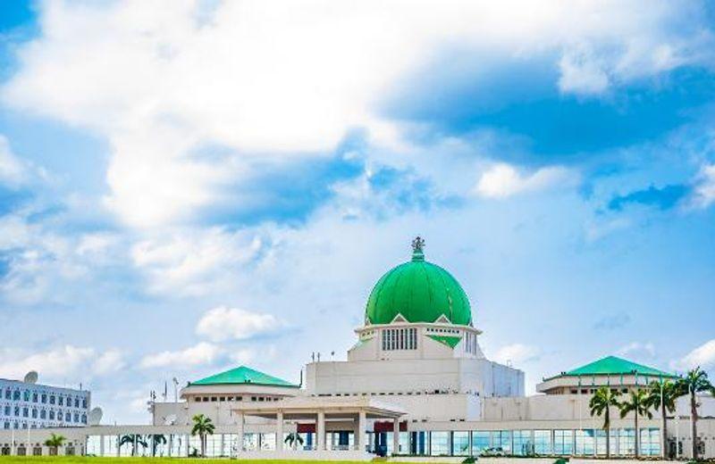 Legislators discussing tax reforms in a session at the National Assembly, highlighting the proposed changes to VAT and corporate income tax rates.
