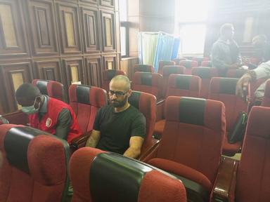 Tigran Gambaryan is seen in court with an operative of the EFCC. Credit: Punch