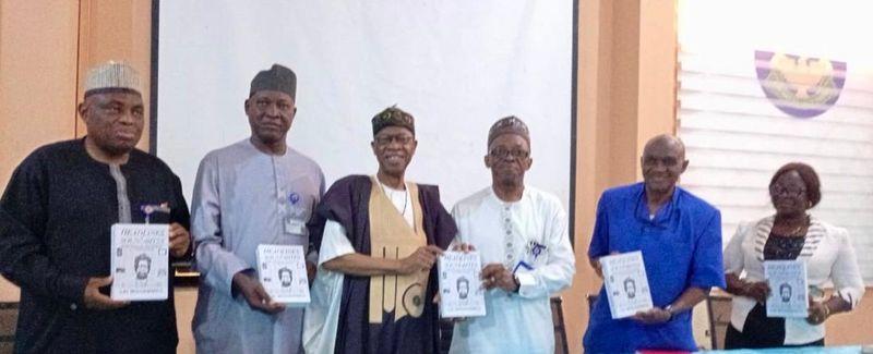 Lai Mohammed presenting copies of his book at the University of Ilorin during an academic event.