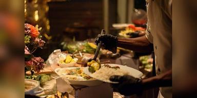 Chef serving Nigerian food at a buffet in Enugu, used as illustrative food-service imagery.