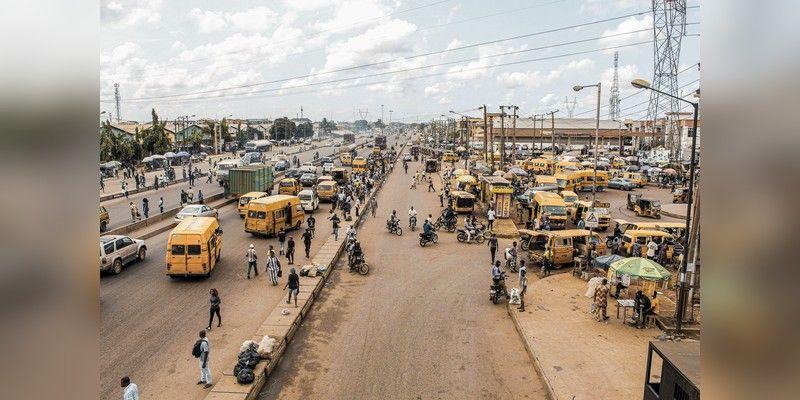 Wide Lagos street scene with traffic and pedestrians, used as illustrative urban context.