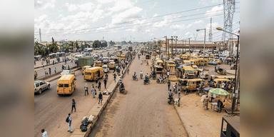 Wide Lagos street scene with traffic and pedestrians, used as illustrative urban context.