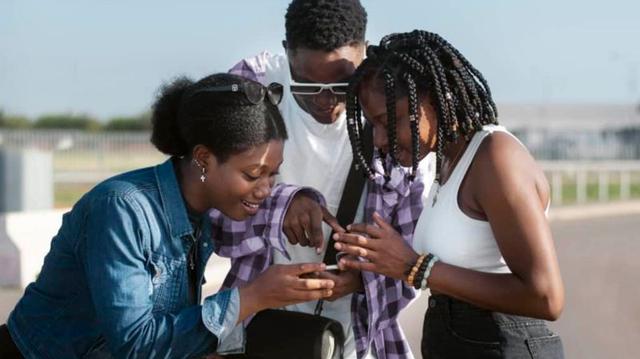 Young Nigerians using smartphones and social media platforms to create content, engage online and explore digital opportunities in a connected world.