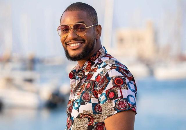 Alex Ekubo smiling at a public event before reports emerged of his death after battling stage 4 liver cancer.