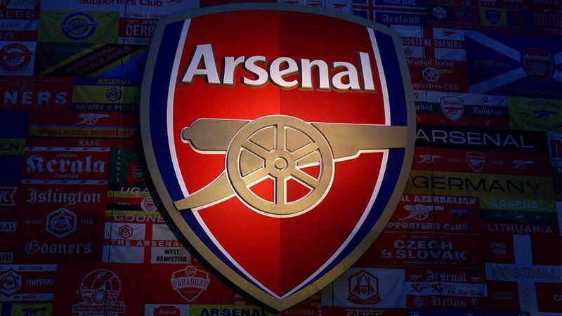 Arsenal players celebrating on the pitch after a Premier League match as transfer speculation builds ahead of the summer window.