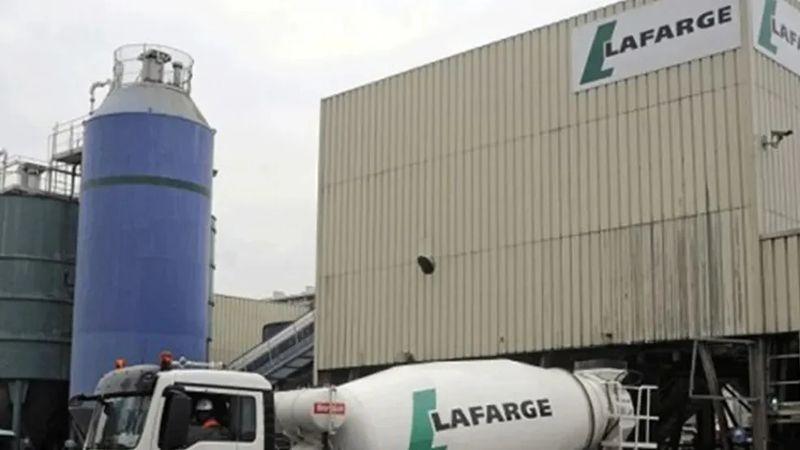 Lafarge Africa cement plant with trucks and silos, symbolising record revenue and profit achievement for 2025.