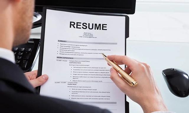 A job seeker reviewing and updating an ATS-friendly resume on a laptop before submitting a job application.