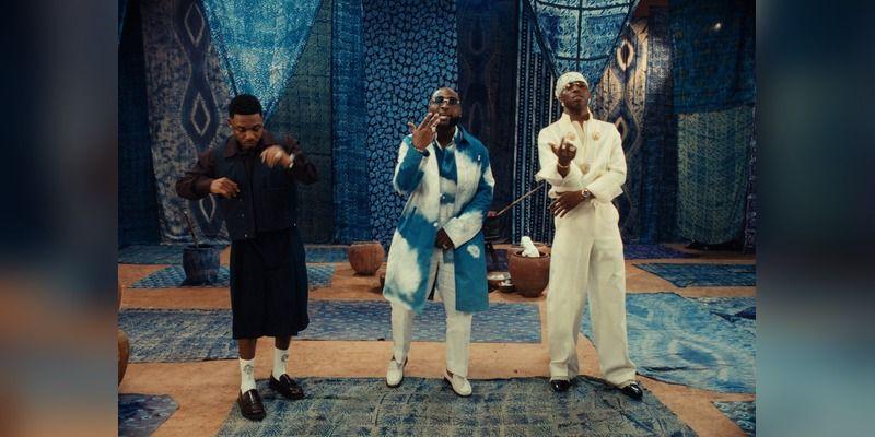 Davido, Mayorkun and FOLA perform in front of layered indigo Àdìrẹ textiles in the B4 B4 video.