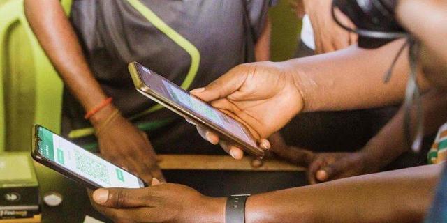 People using mobile banking apps on their smartphones in Nigeria