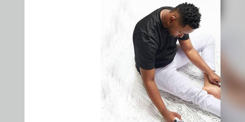 Dr Fola David works on a large-scale drawing.