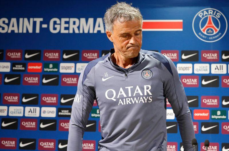 PSG coach Luis Enrique celebrates with the UEFA Champions League trophy after defeating Arsenal in the final.