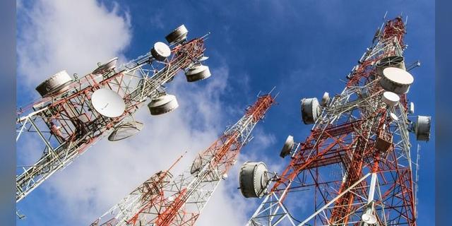 Telecommunications masts against a blue sky, illustrating Nigeria’s internet-data infrastructure.