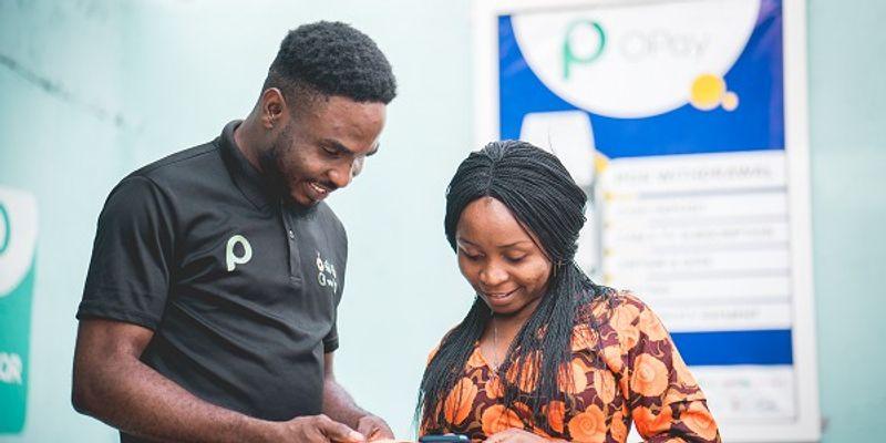 An OPay representative assists a customer with a digital payment in Nigeria.