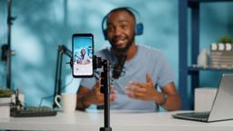 A Nigerian content creator managing multiple social media platforms, an email newsletter and digital income streams from a laptop.