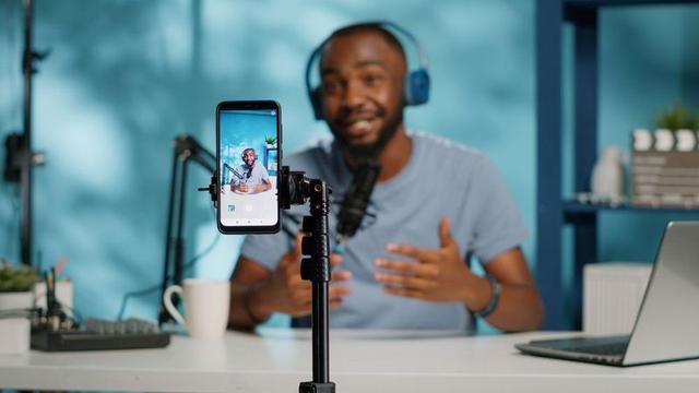 A Nigerian content creator managing multiple social media platforms, an email newsletter and digital income streams from a laptop.