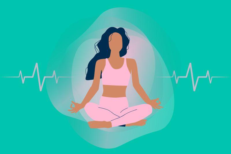 Person sitting comfortably with eyes closed while practising a mindful breathing exercise in a peaceful indoor setting.